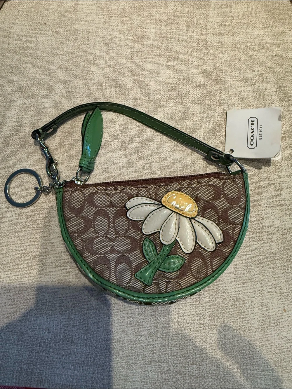 Coach Brown Signature Wristlet with Green Trim and Daisy Motif